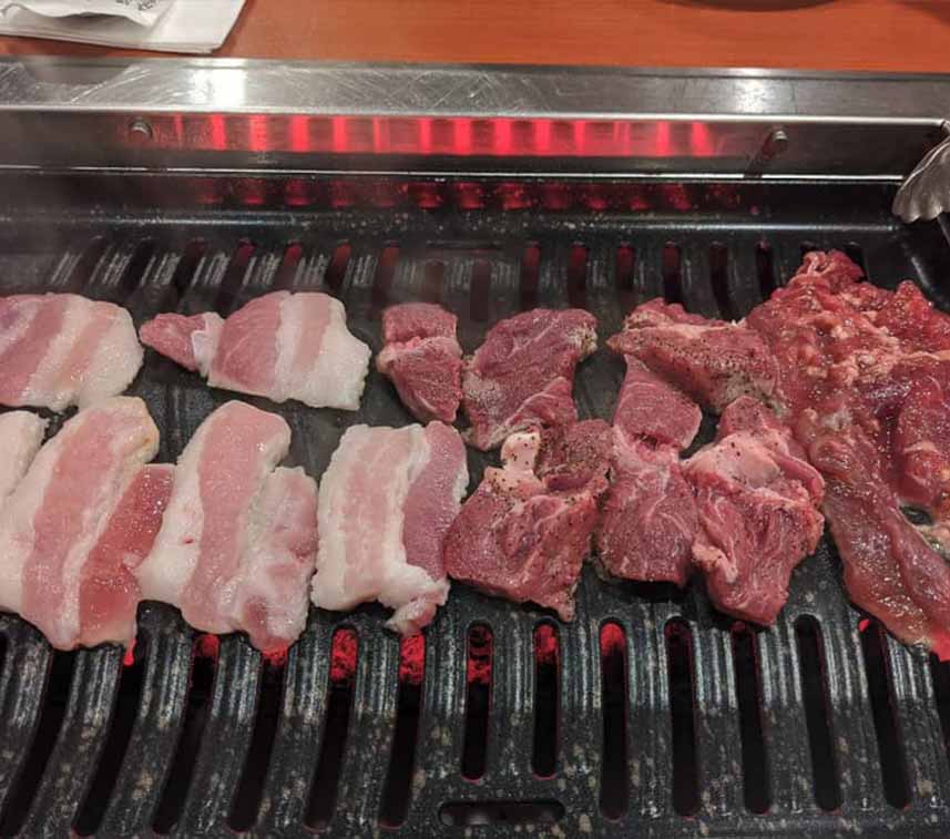 Korean BBQ meat on the grill at Korea Garden restaurant in Blue Bell, PA. Serving authentic Korean BBQ and traditional Korean cuisine to Montgomery County.